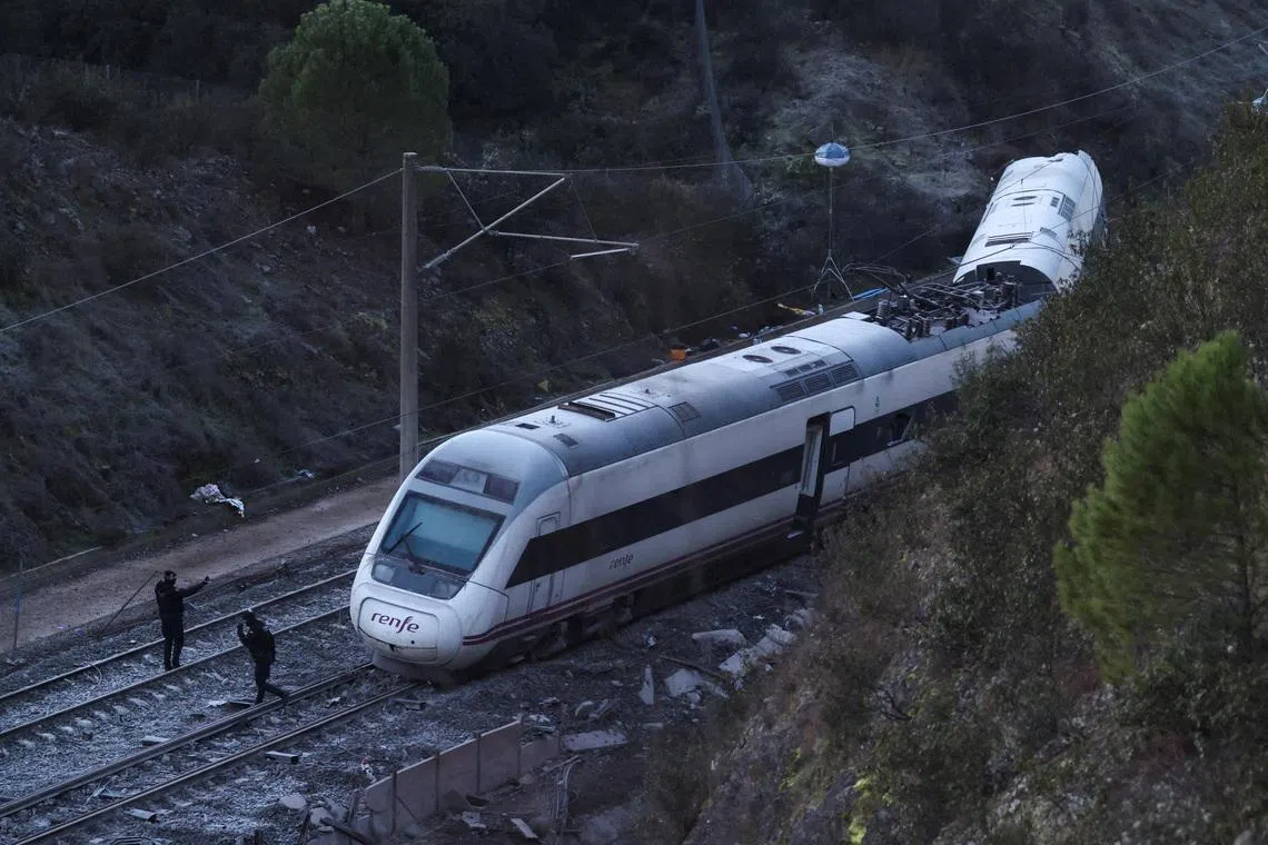 Emergency personnel work next to one of the trains involved in the accident, near Adamuz, in Cordoba, Spain, January 19. REUTERS/Susana Vera