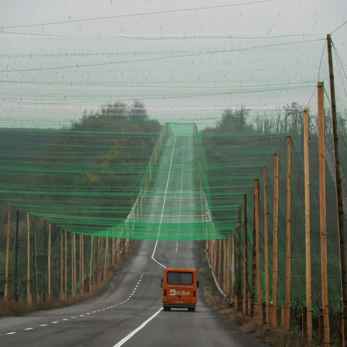 A car drives along a road covered with an anti-drone net amid Russia’s attack on Ukraine, near the town of Sloviansk in the Donetsk region, Ukraine on Oct 27, 2025.   