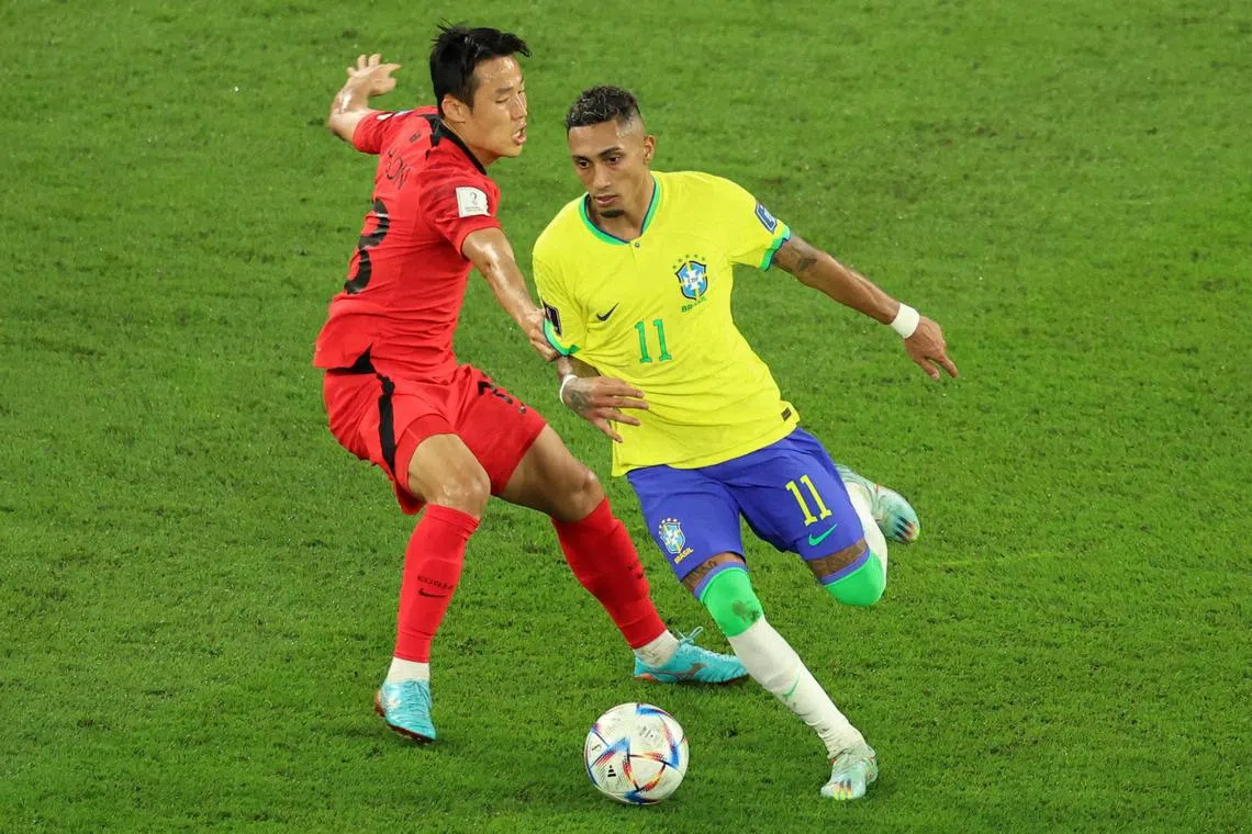 South Korea's Son Junho in action against Brazil's Raphinha at the Fifa World Cup in December 2022.