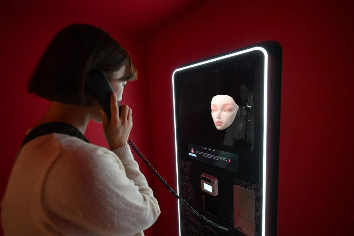 A woman speaks with an artificial intelligence-assisted shaman robot on display in a machine in Seoul, South Korea, on April 15. 