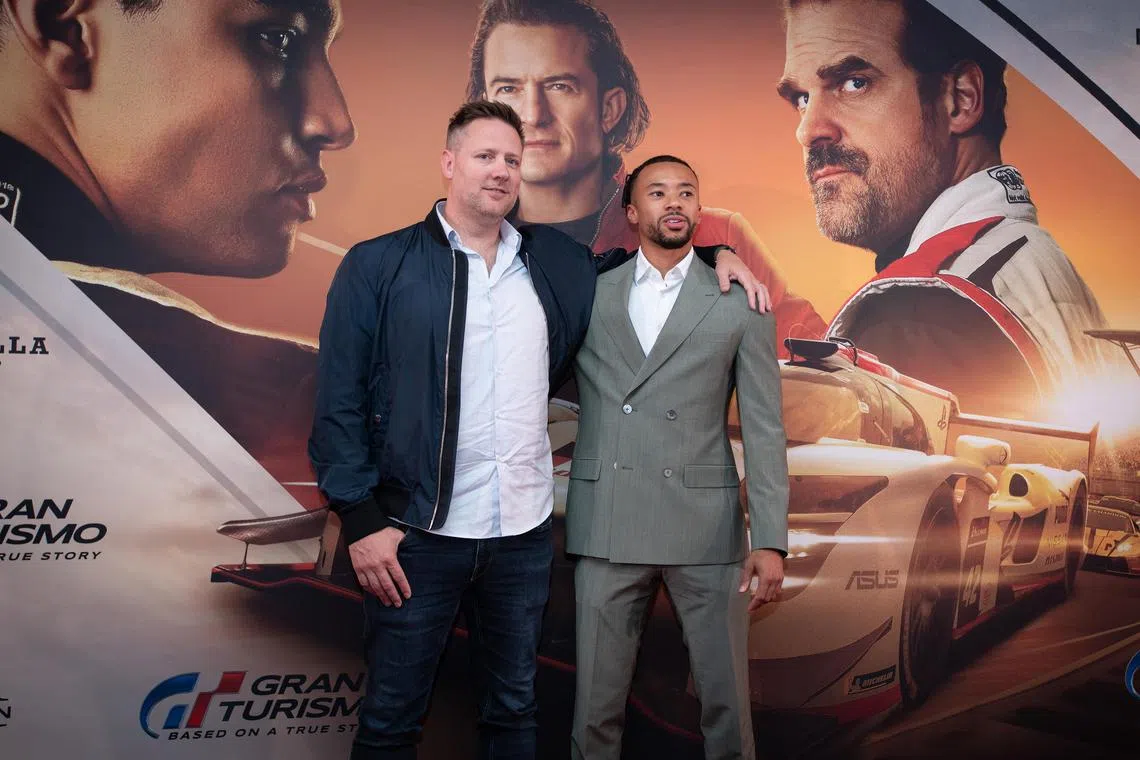 Director Neill Blomkamp (left) and Gran Tursimo gamer-turned-racecar driver Jann Mardenborough promoting the film Gran Turismo.