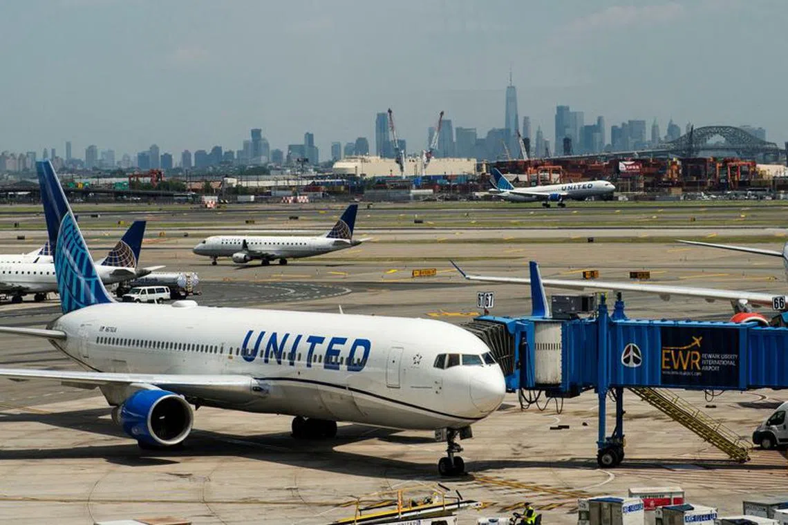 FILE PHOTO: The One World trace Center and the New York skyline are seen while United Airlines planes use the tarmac at Newark Liberty International Airport in Newark, New Jersey, U.S., May 12, 2023. REUTERS/Eduardo Munoz/File Photo