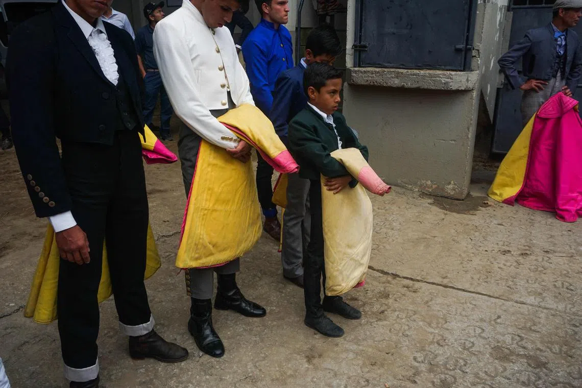 Nine-year-old Cesar Paredes waits to perform in the first bullfighting schools competition in Merida state, Venezuela.