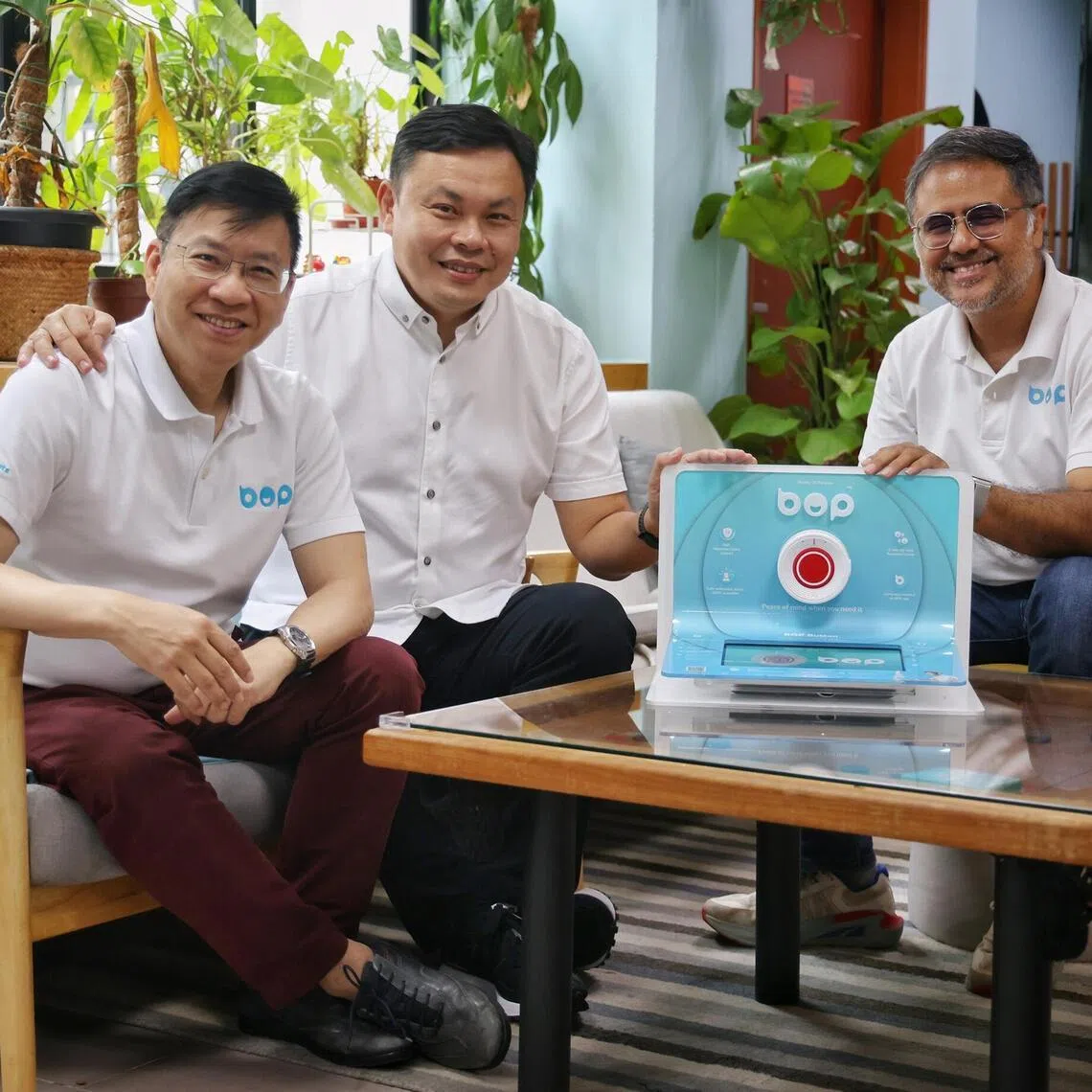 (From left) IOT Solutions' executive vice-president Chen Jer Yaw, CEO Raymond Bo and chief marketing officer Ashokan Ramakrishnan with iWow Technology's wireless alarm system for seniors.