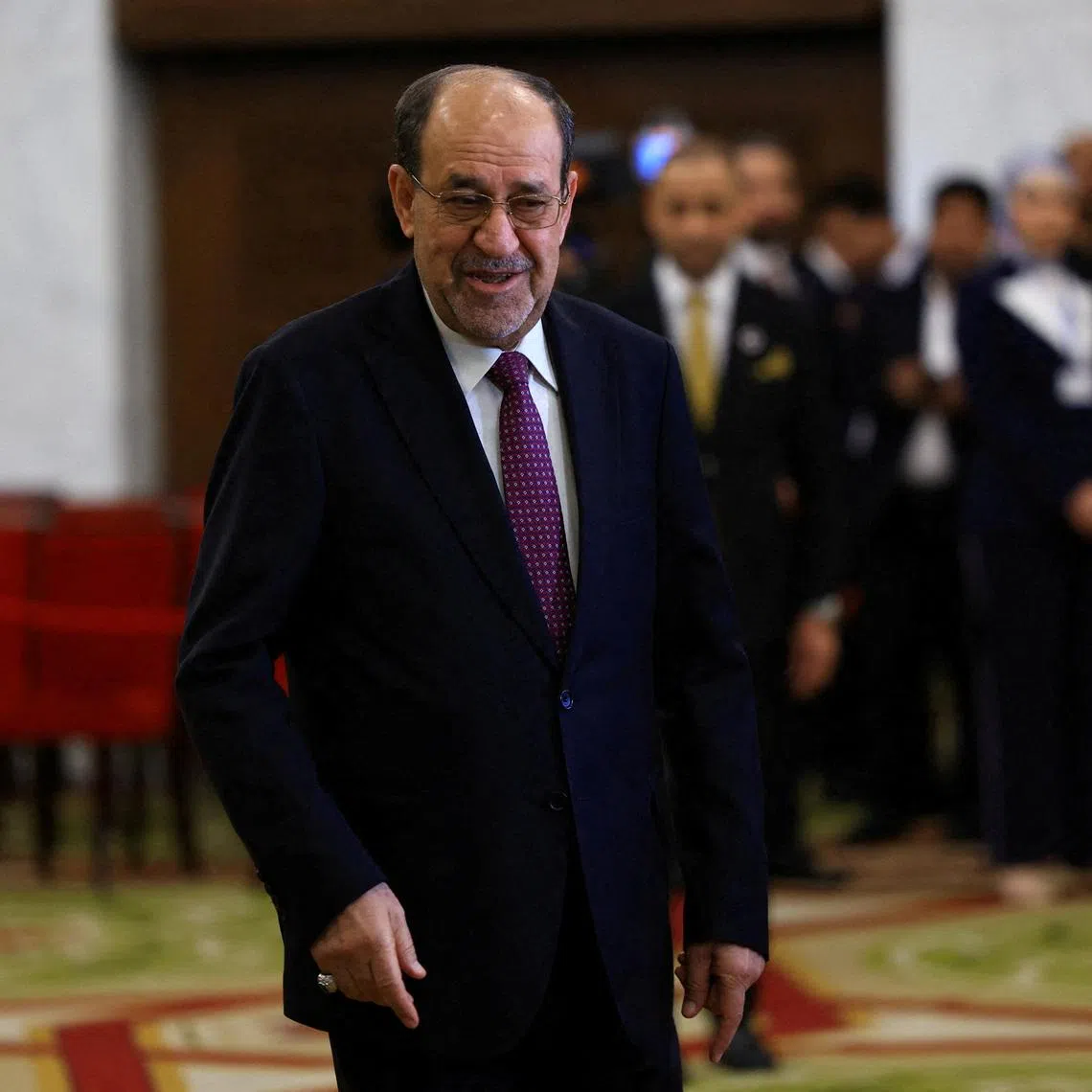 FILE PHOTO: Former Iraqi Prime Minister Nouri al-Maliki walks at a polling station inside Al-Rasheed Hotel during the parliamentary election in Baghdad, Iraq, November 11, 2025. REUTERS/Thaier Al-Sudani/File Photo