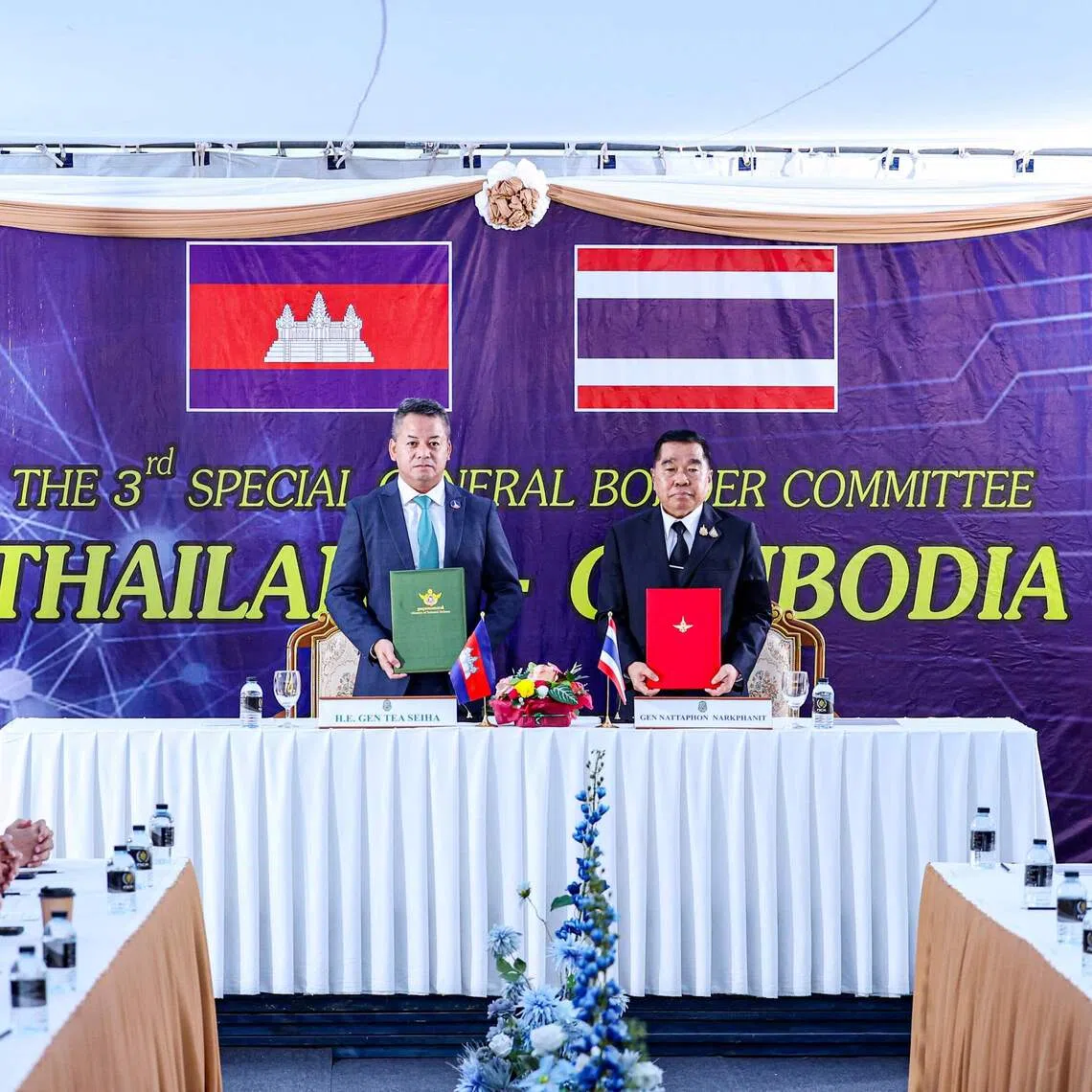 Cambodia's Defence Minister Tea Seiha (left) and Thailand's Defence Minister Nattaphon Narkphanit posing with documents during the special General Border Committee meeting on Dec 27.