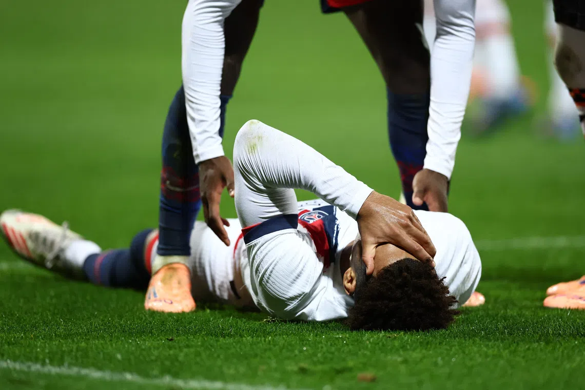 Soccer Football - Ligue 1 - FC Lorient v Paris St Germain - Stade du Moustoir, Lorient, France - October 29, 2025  Paris St Germain's Desire Doue reacts after sustaining an injury REUTERS/Stephane Mahe