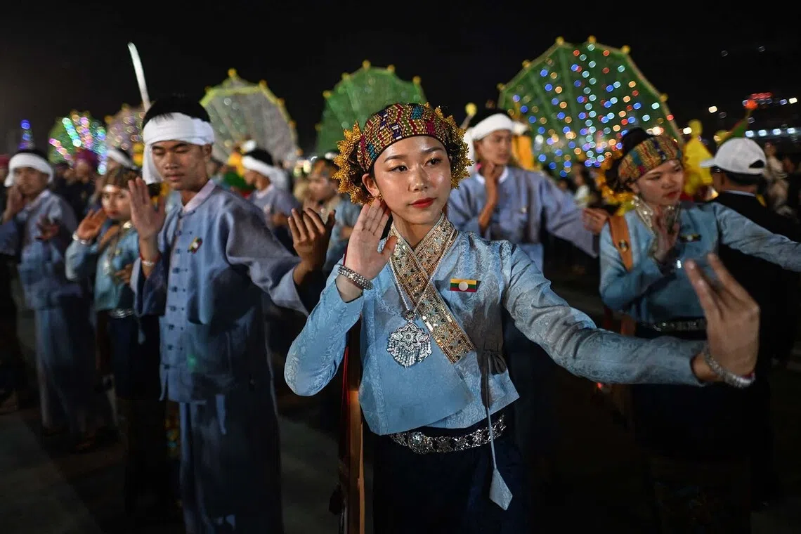 Shan ethnic women performing a traditional dance on the opening day of the week-long Tazaungdaing Lighting Festival in Taunggyi, Myanmar's northeastern Shan State, Oct 29, 2025.