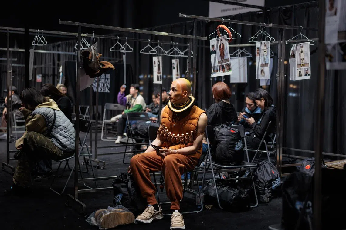 A model backstage waiting for the Staffonly runway presentation to begin, during the Shanghai Fashion Week Autumn/Winter 2023 in Shanghai, China, March 30.