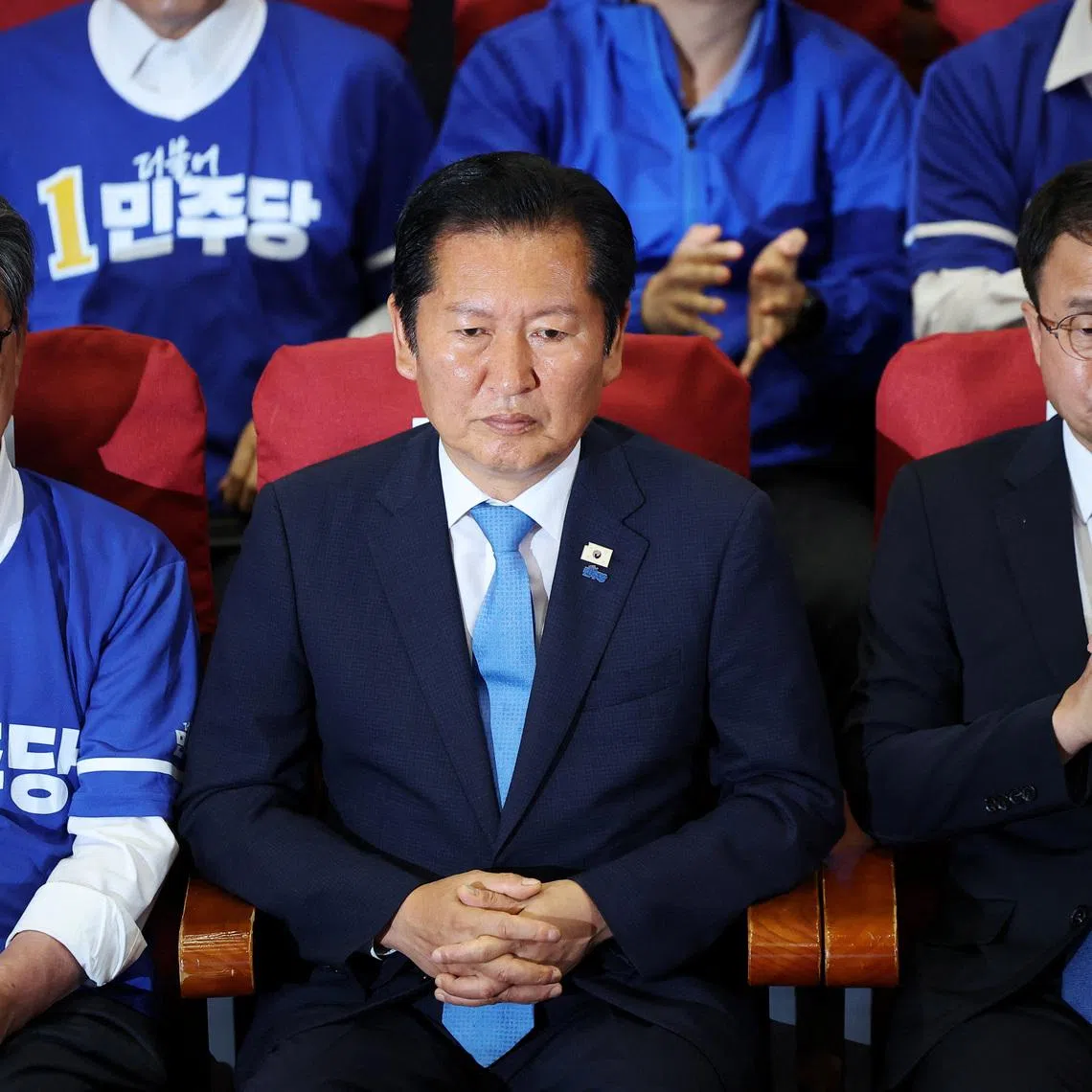 South Korea's ruling Democratic Party leader Jung Chung-rae, and lawmakers watch a news report on the results of exit polls for the local elections at the National Assembly in Seoul, South Korea, June 3, 2026.     REUTERS/Kim Hong-Ji