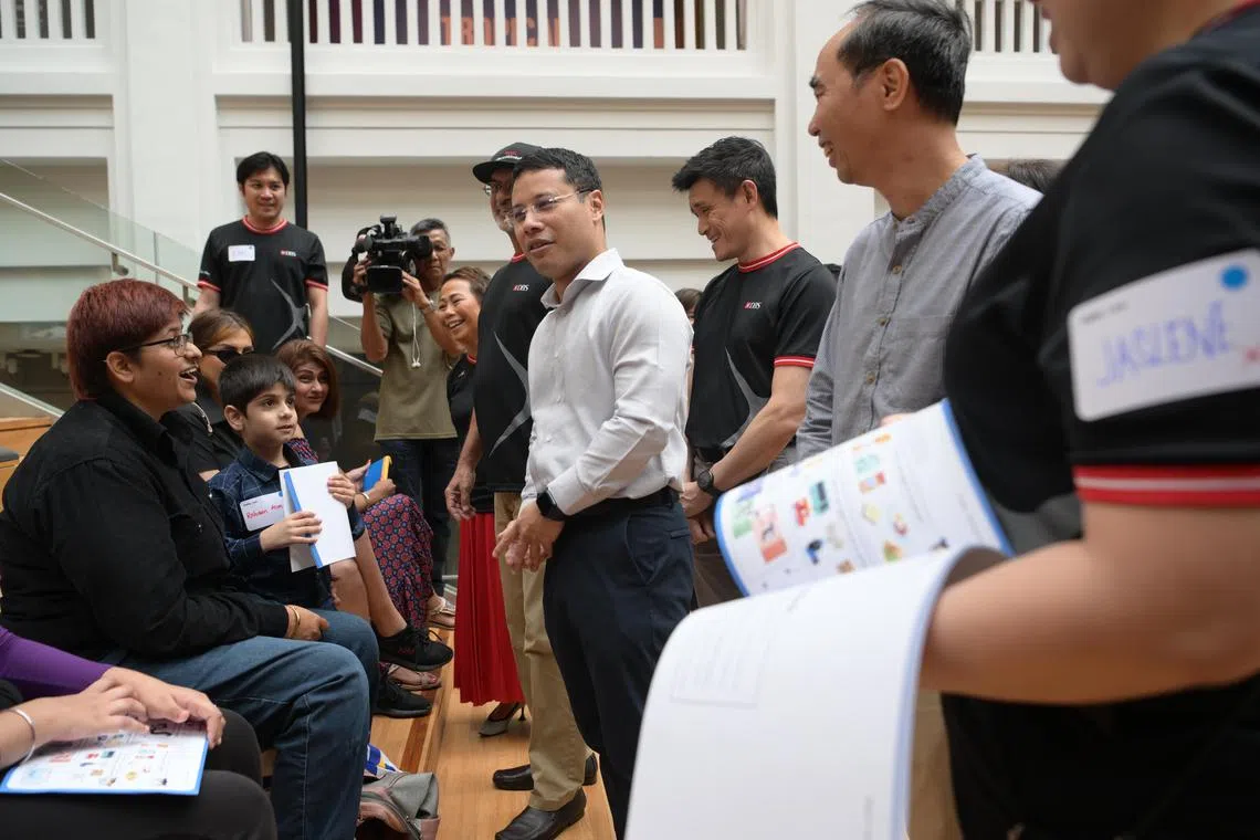 Minister for National Development Desmond Lee with Madam Kalwinder Jit Kaur (second from left), 34 at DBS and MSF’s announcement of a new partnership to help lower-income families with children living in rental flats. This includes contributing financial expertise and resources, and a volunteer befriender programme. DBS CEO Piyush Gupta on minister’s right.