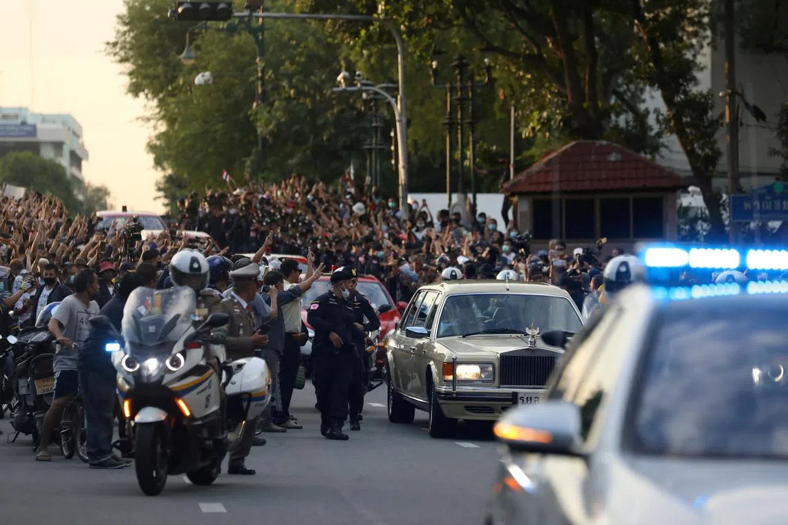 FILE PHOTO: The royal motorcade carrying Thailand's Queen Suthida and Prince Dipangkorn drives past a group of anti-government demonstrators in front of Government House, on the 47th anniversary of the 1973 student uprising, in Bangkok, Thailand October 14, 2020. Picture taken October 14, 2020. To match Insight THAILAND-PROTESTS/MOTORCADE , picture 10 in a sequence of 12 images. REUTERS/Soe Zeya Tun/File Photo