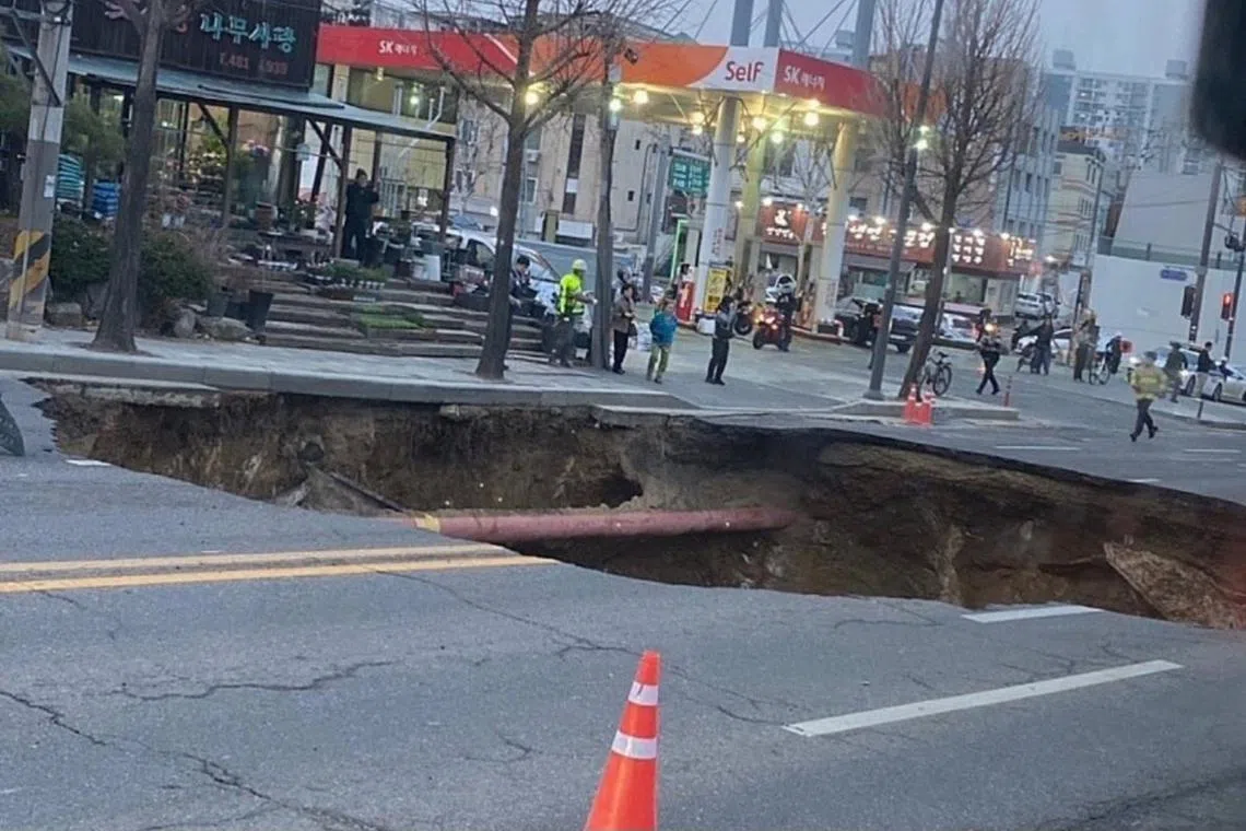 A car driver who was passing down the road just before the collapse was also injured and sent to a hospital.