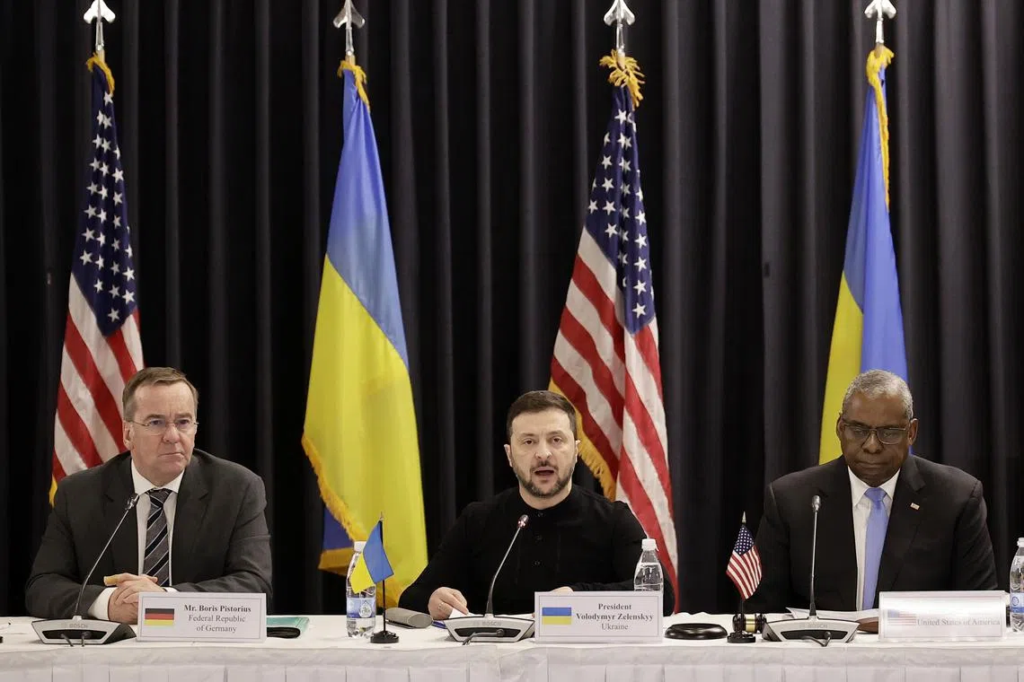 Ukrainian President Volodymyr Zelensky (centre) speaking at the Ramstein meeting next to US Secretary of Defence Lloyd Austin (right) and German Defence Minister Boris Pistorius.