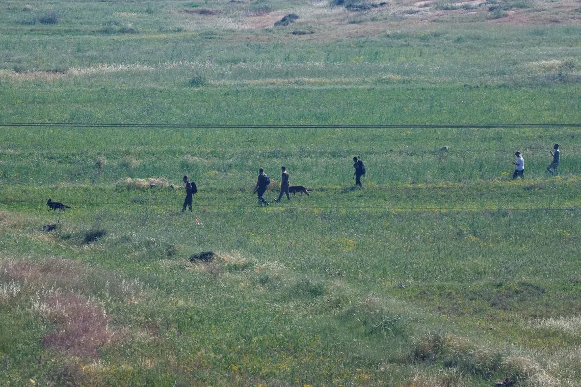 Israeli settlers look for a 14-year-old, who according to the Israeli military went missing in the area near the village of al-Mughayyer, in the Israeli-occupied West Bank, April 13, 2024. REUTERS /Mohammed Torokman