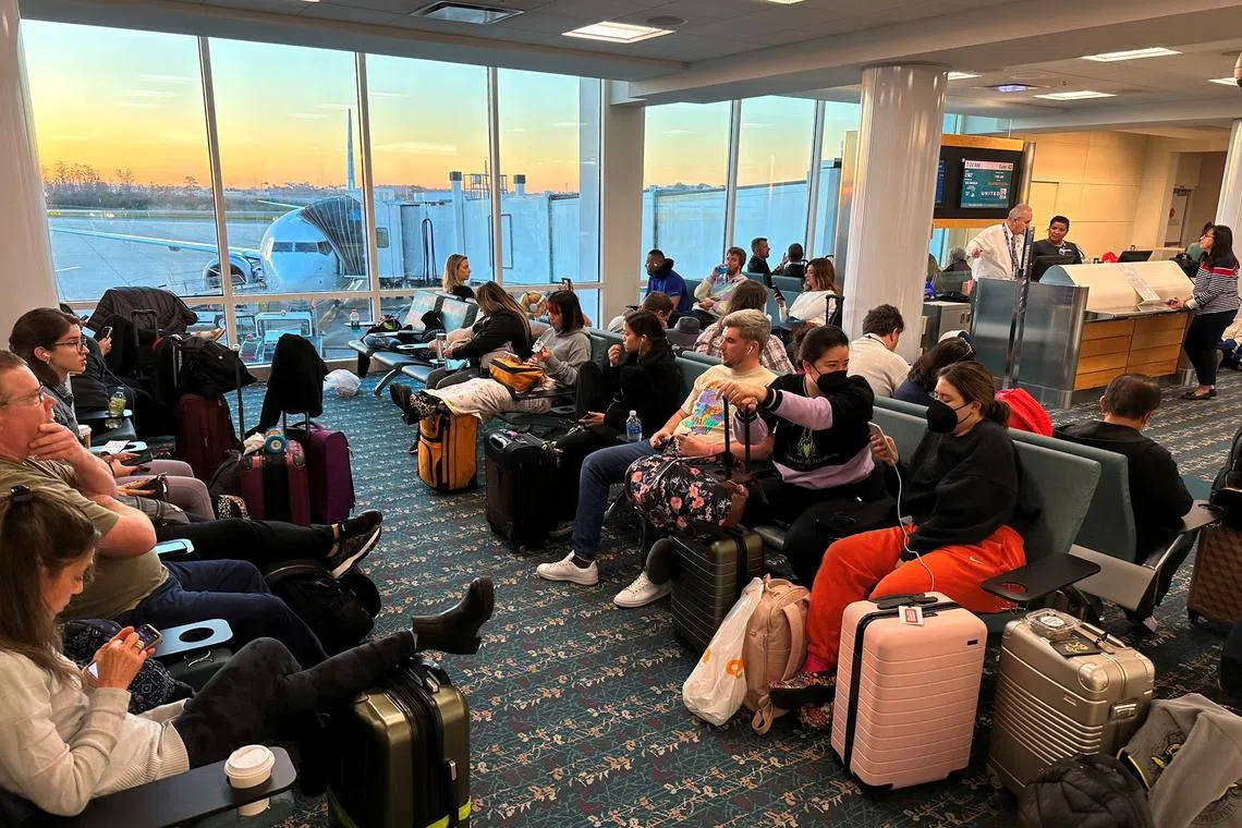 Stranded passengers wait at the Orlando International Airport, as flights were grounded after an FAA system outage, on Jan 11, 2023.