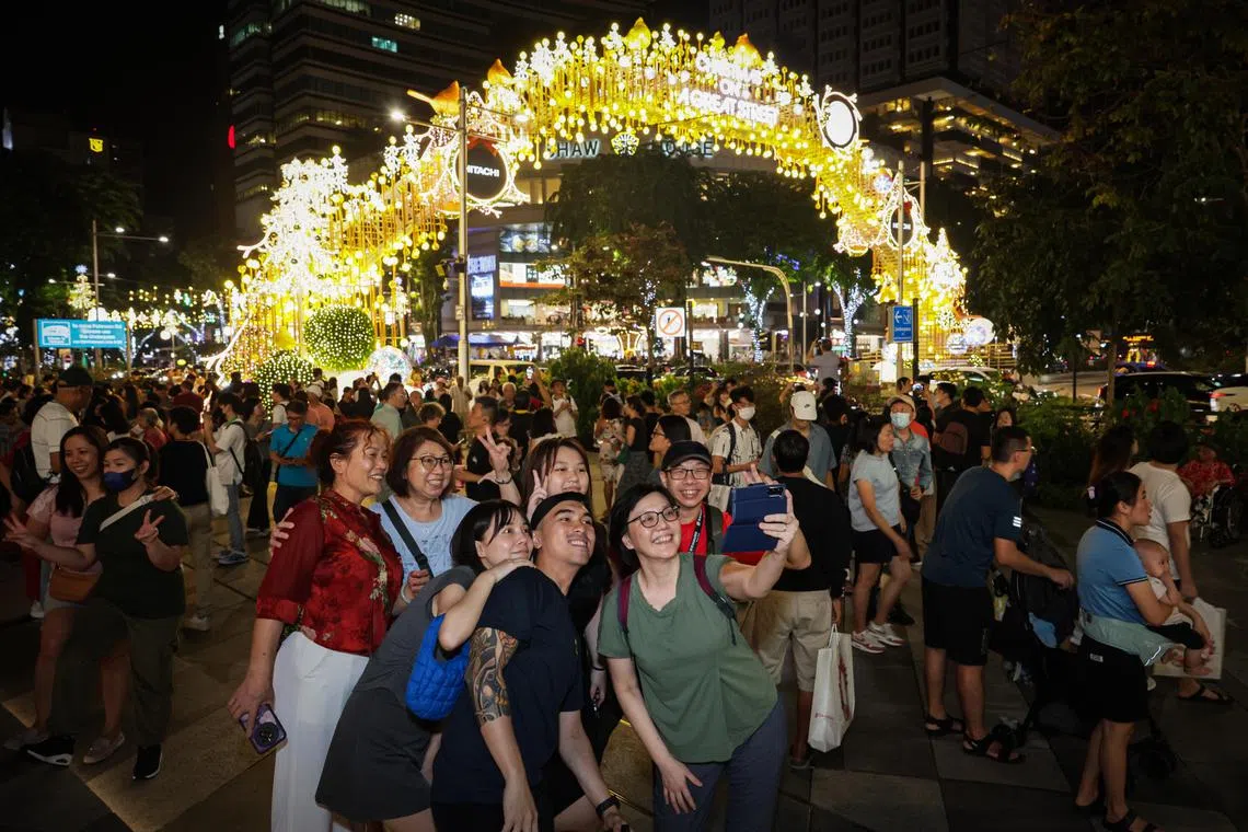 People taking photo after the Christmas On A Great Street Community Chest Light-Up Ceremony at Orchard Road on Nov 9. 