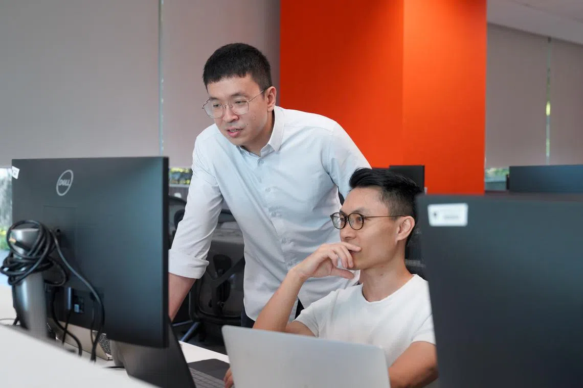 ai solutions team principal engineer kelvin ang working with colleague on artificial intelligence tools for shopee
