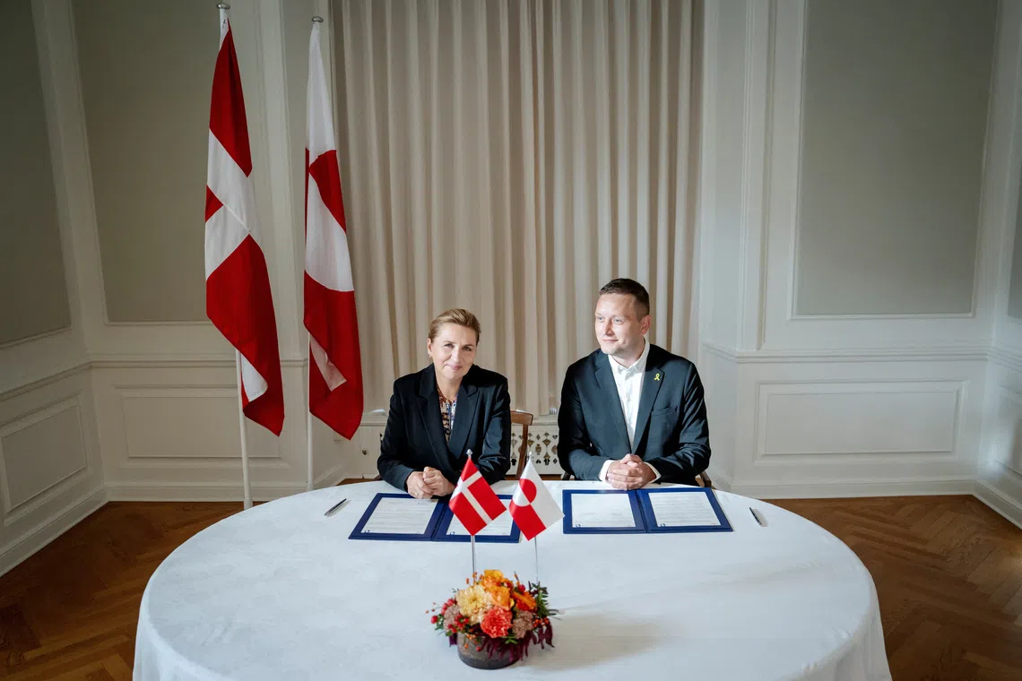 Denmark's Prime Minister Mette Frederiksen (left) and Greenland's Prime Minister Jens-Frederik Nielsen signing a framework agreement for a self-sustaining Greenland on Sept 16.