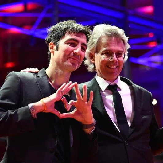 Ilker Catak (left) and Ingo Fliess pose with the Golden Bear for Best Film for Gelbe Briefe (Yellow Letters) at the closing ceremony of the 76th Berlin International Film Festival, in Berlin, Germany, on Feb 21.