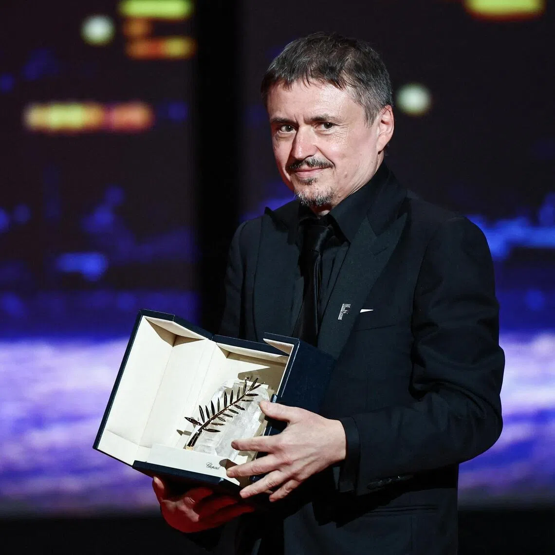 Director Cristian Mungiu posing with his Palme d'Or for the film Fjord, at the closing ceremony of the 79th Cannes Film Festival in Cannes, France, on May 23.
