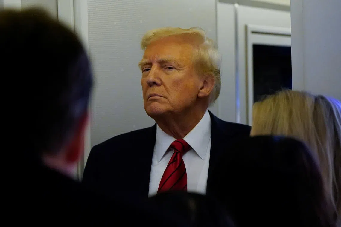 FILE PHOTO: U.S. President Donald Trump looks on as he speaks to reporters aboard Air Force One before arriving at Joint Base Andrews, Maryland, U.S., January 27, 2025. REUTERS/Elizabeth Frantz/File Photo