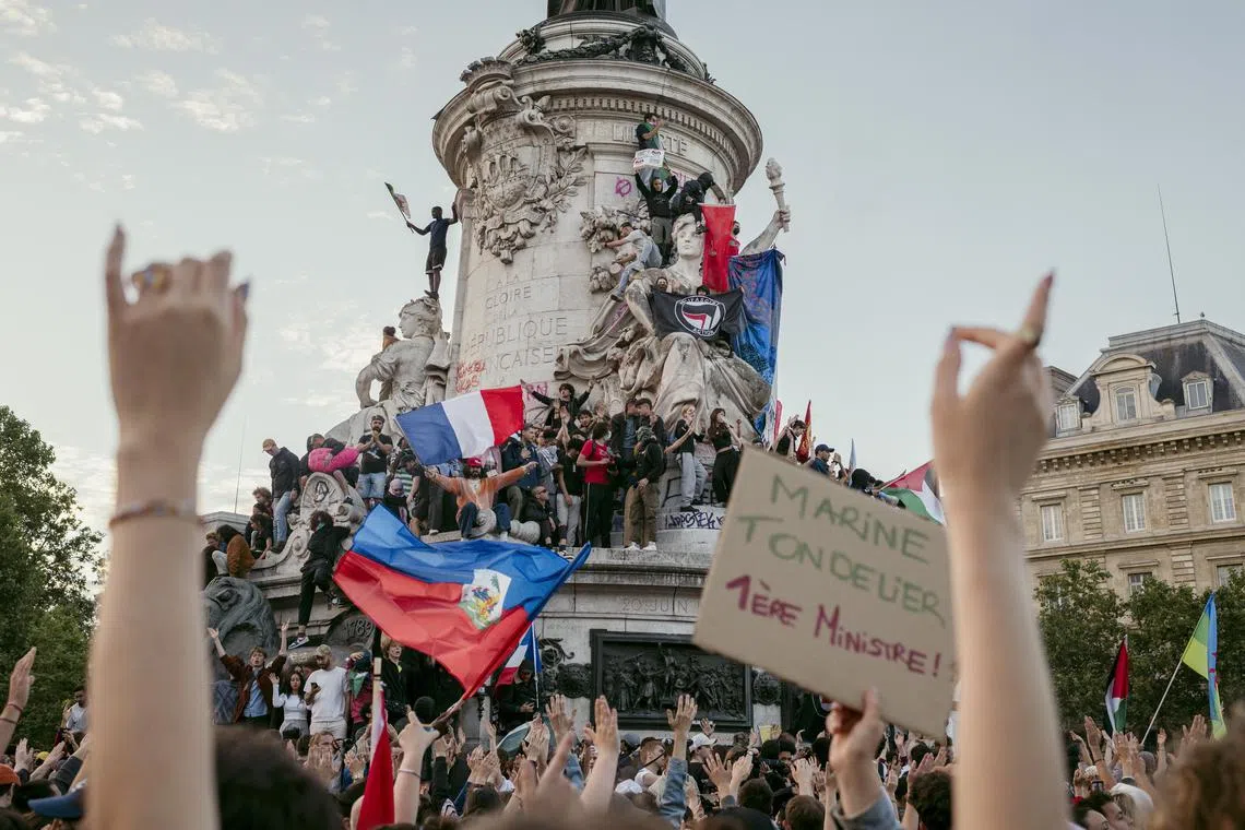 People celebrate after the second round of the French legislative elections at Place de la Republic in Paris, on Sunday, July 7, 2024. The far-right National Rally appeared to have fallen short of predictions, but no coalition captured an absolute majority in Parliament, according to projections. Months of gridlock could lie ahead. (Dmitry Kostyukov/The New York Times)
