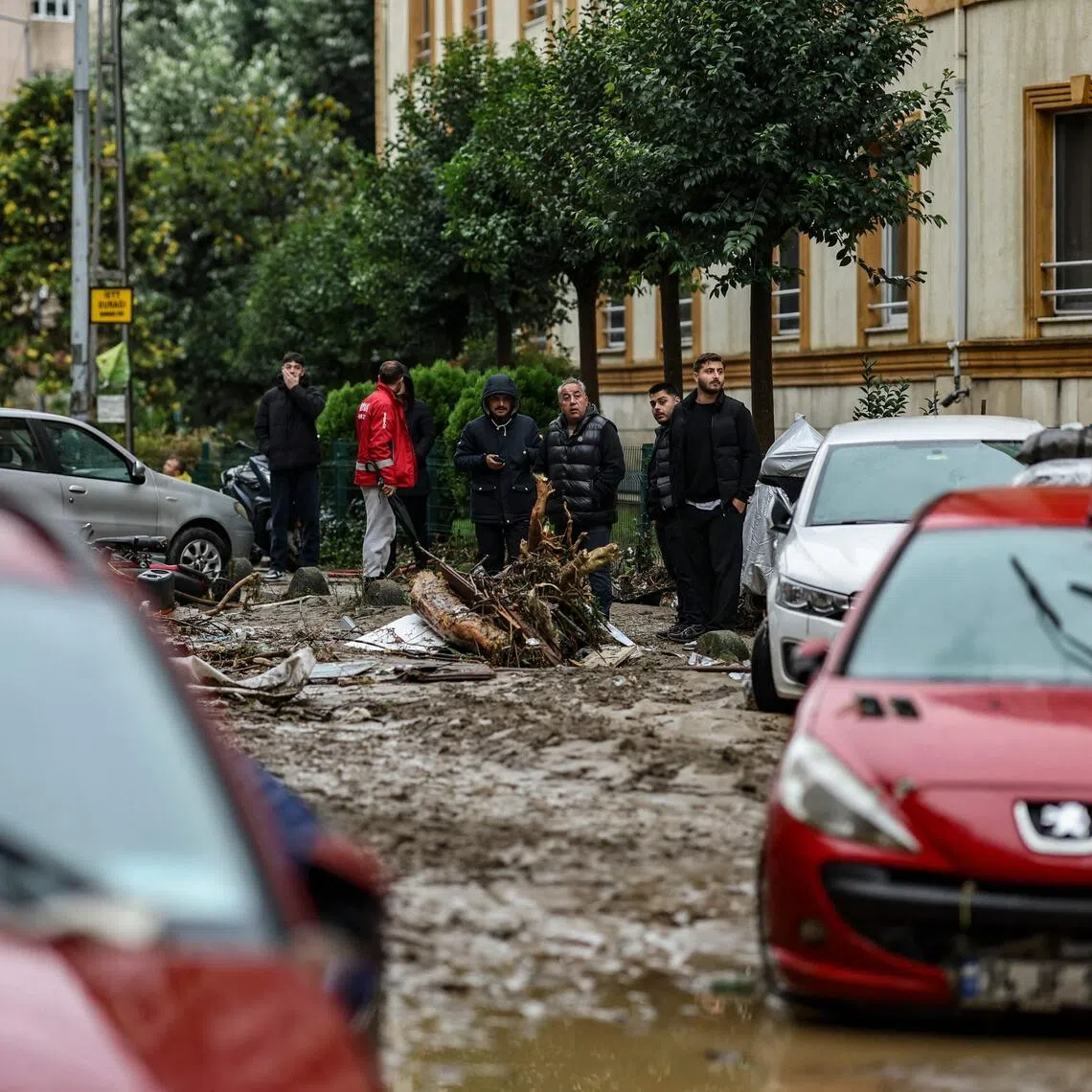 Car owners searching for their vehicles swept away by the flood after a heavy rain at Ayazaga district in Istanbul, on Oct 15.