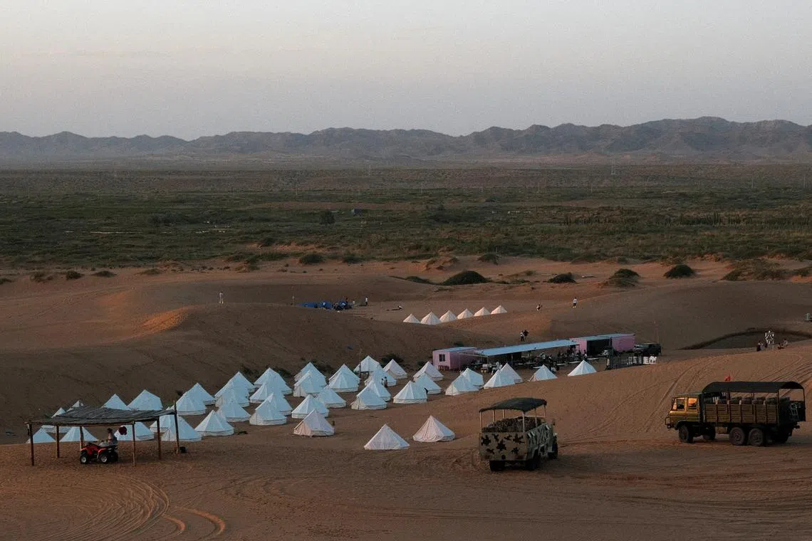 FILE PHOTO: Tourists on desert safari trips stay in tents in Tengger Desert in Ningxia Hui Autonomous Region, China July 26, 2021. Picture taken July 26, 2021. REUTERS/Ryan Woo/File Photo