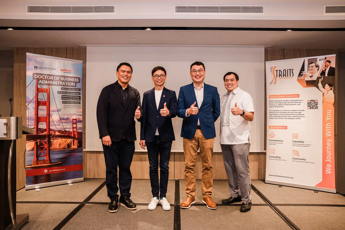 NTUC assistant secretary-general Patrick Tay announces the collaboration with ASME president Ang Yuit, SMU Academy executive director Jack Lim and Straits Interactive founder and CEO Kevin Shepherdson. 