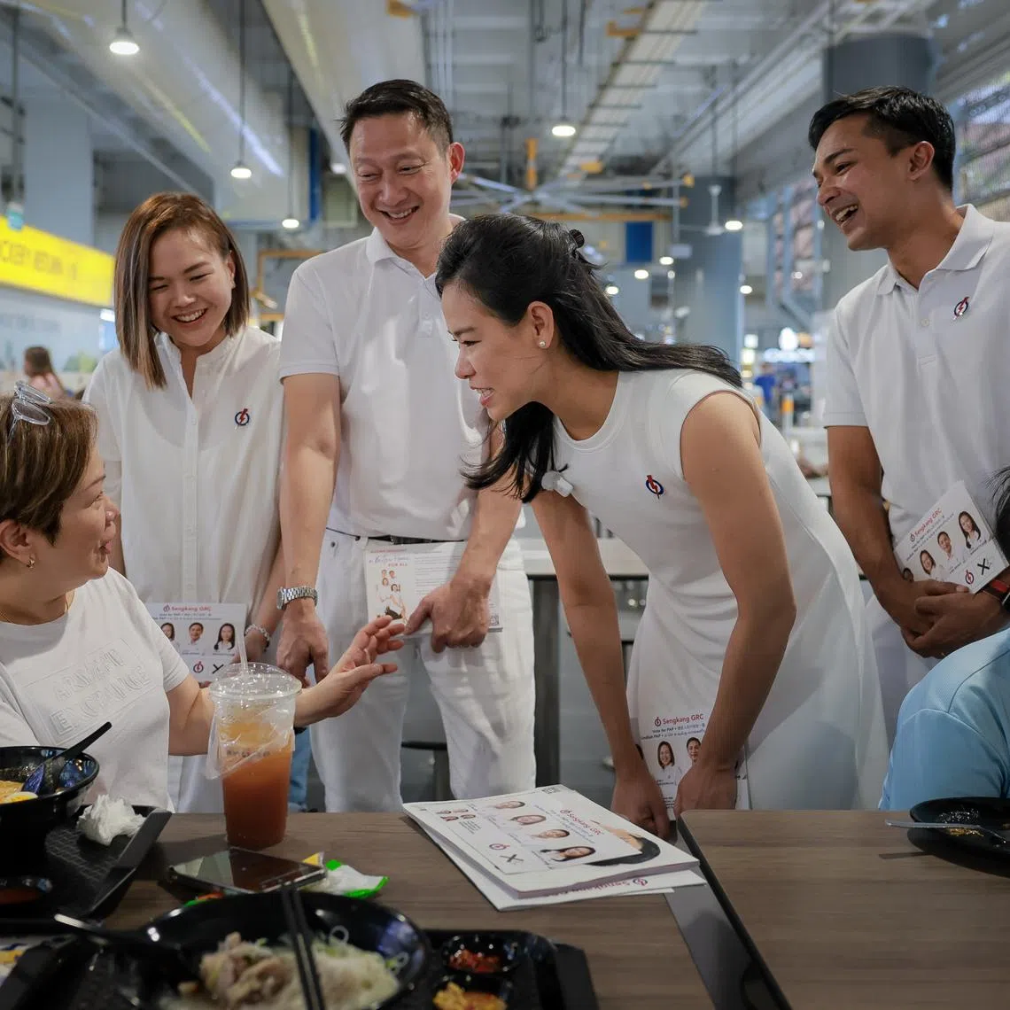The PAP's Sengkang GRC candidates (from left) Theodora Lai, Lam Pin Min, Bernadette Giam and Elmie Nekmat on a walkabout at Anchorvale Food Centre on April 25.