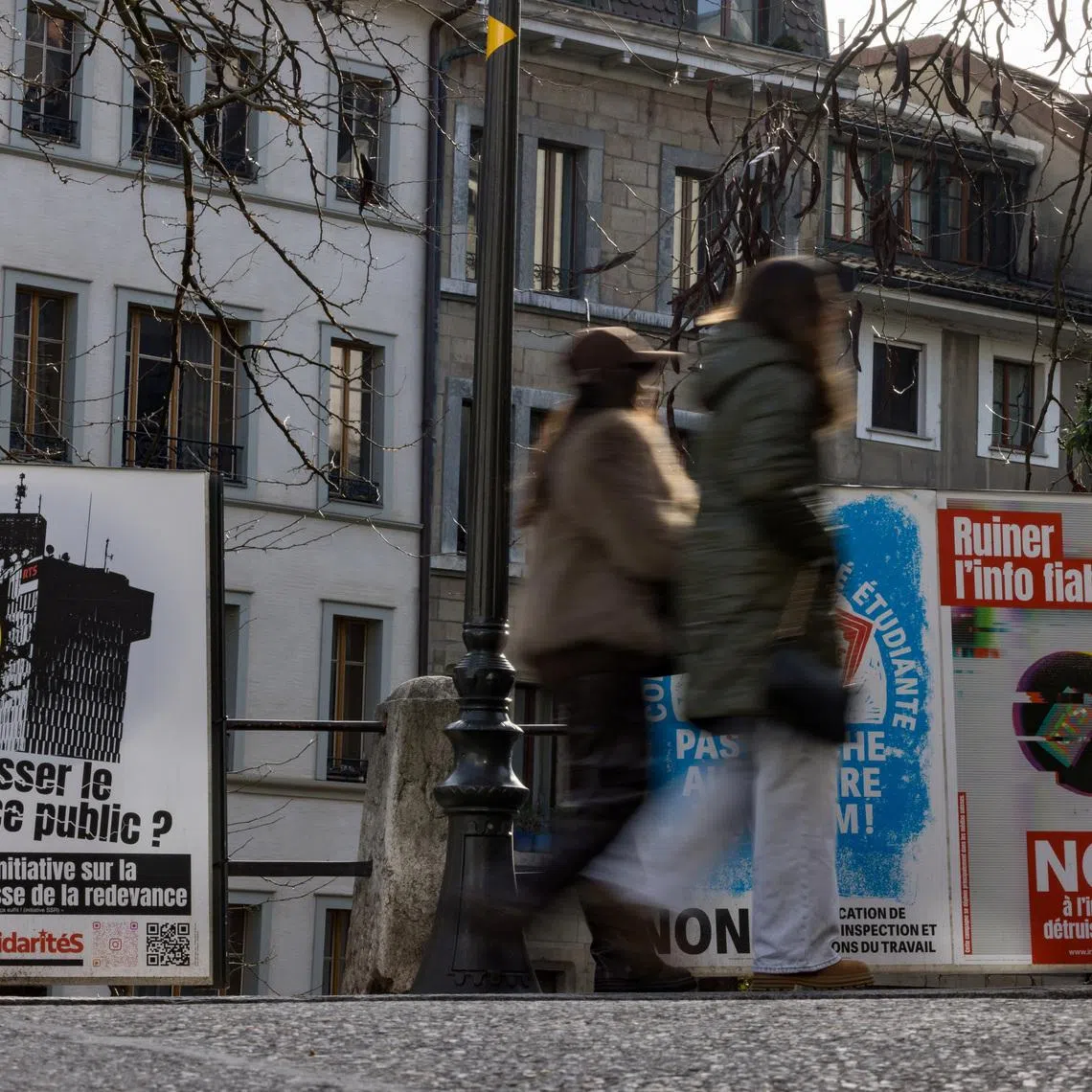 Posters encouring people to vote \"no\" to the funding cuts for the SRG SSR (Swiss Broadcasting Corporation), ahead of the upcoming Swiss national referendum on March 8, in Geneva, Switzerland, February 15, 2026. REUTERS/Pierre Albouy