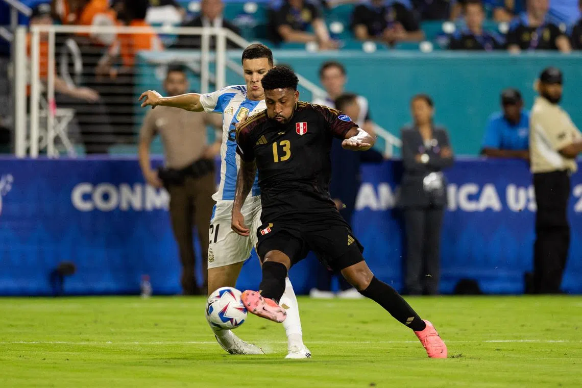 Jun 29, 2024; Miami, FL, USA;  Argentina midfielder Valentin Carboni (21) and Peru midfielder Jesus Castillo (13) battle for the ball in the second half during a Copa America group stage match at Hard Rock Stadium. Mandatory Credit: Nathan Ray Seebeck/File Photo