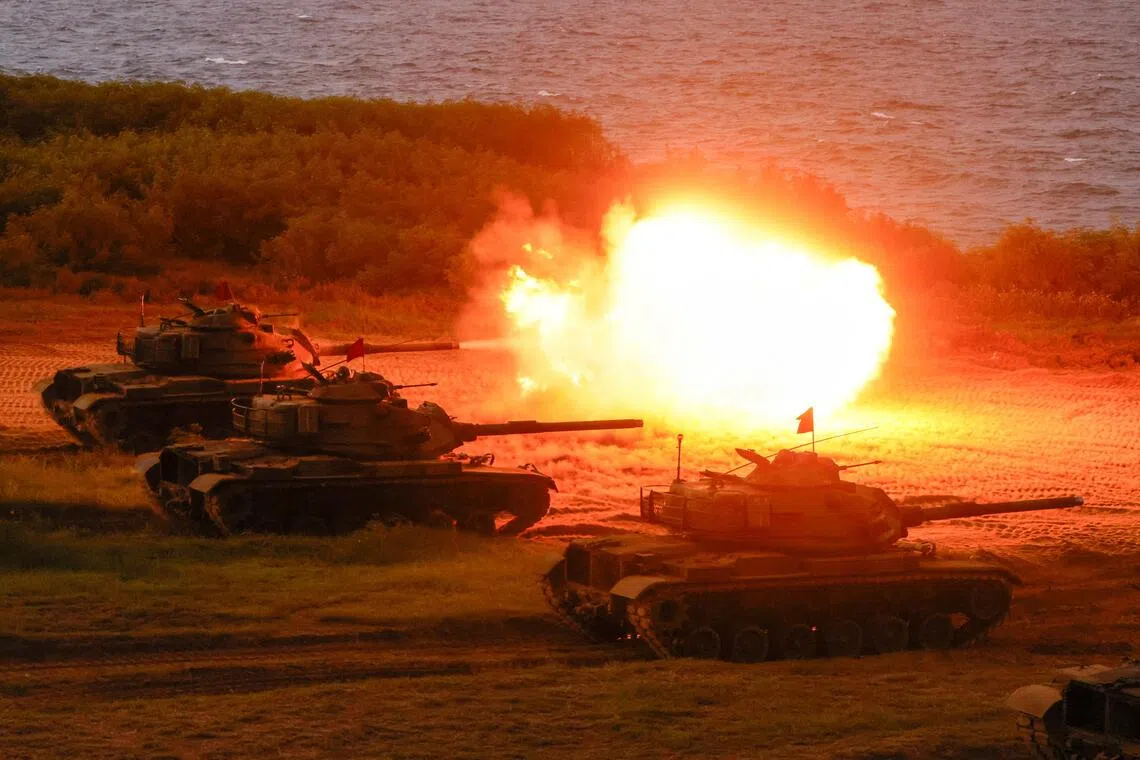 Main battle tanks fire during a live-fire drill as part of a military exercise in Penghu, Taiwan, on Aug 10.