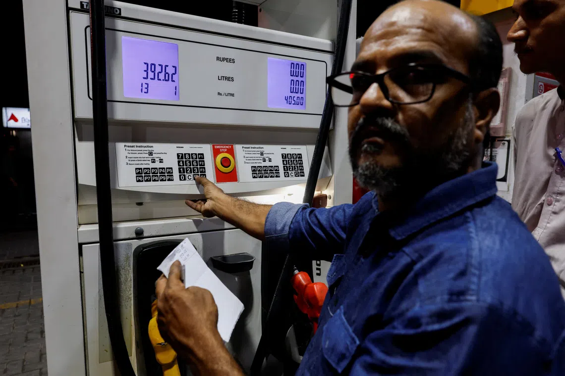 A worker updates the fuel price at a petrol station following the rollout of a fuel relief scheme, which provides a fuel subsidy for eligible motorcycles, rickshaws and vehicles with engines of up to 800cc, in Karachi, Pakistan, September 16, 2026. REUTERS/Akhtar Soomro