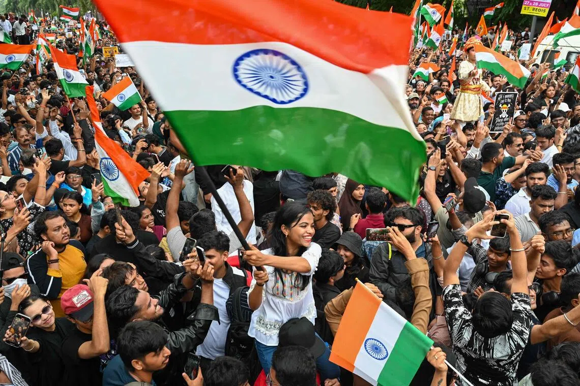 Cockroach Janta Party (CJP) supporters wave national flags a day after the resignation of India’s Education Minister Dharmendra Pradhan in Mumbai on July 26, 2026.