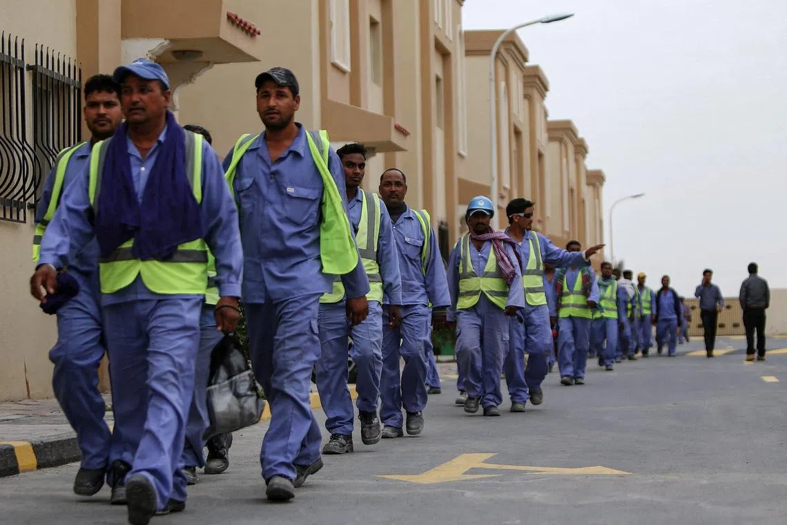 Foreign workers heading back to their accommodations after working on the al-Wakrah football stadium in Qatar in 2015.