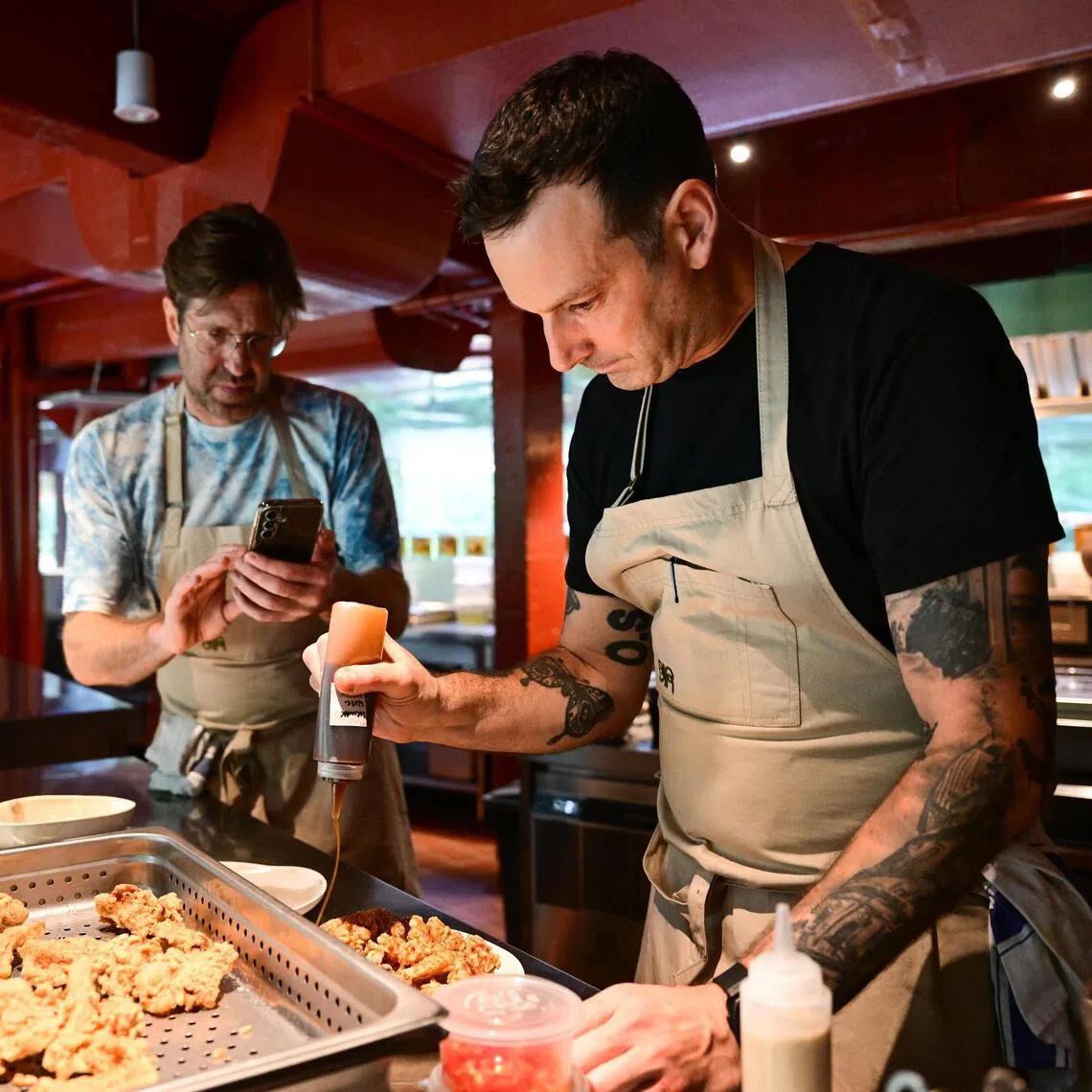 ST20231127_202349206696 hynew Azmi

(From left) Will Goldfarb and Matt Orlando preparing a dish in the kitchen of their new restaurant Air at Dempsey Road.

ST PHOTO: AZMI ATHNI