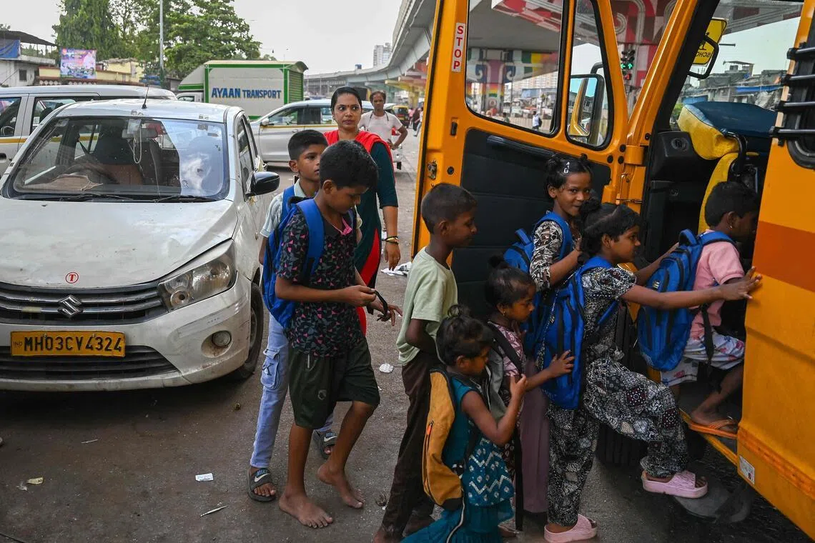 Children board the “Signal Shala”, or traffic signal school’s bus in Mumbai on May 25.