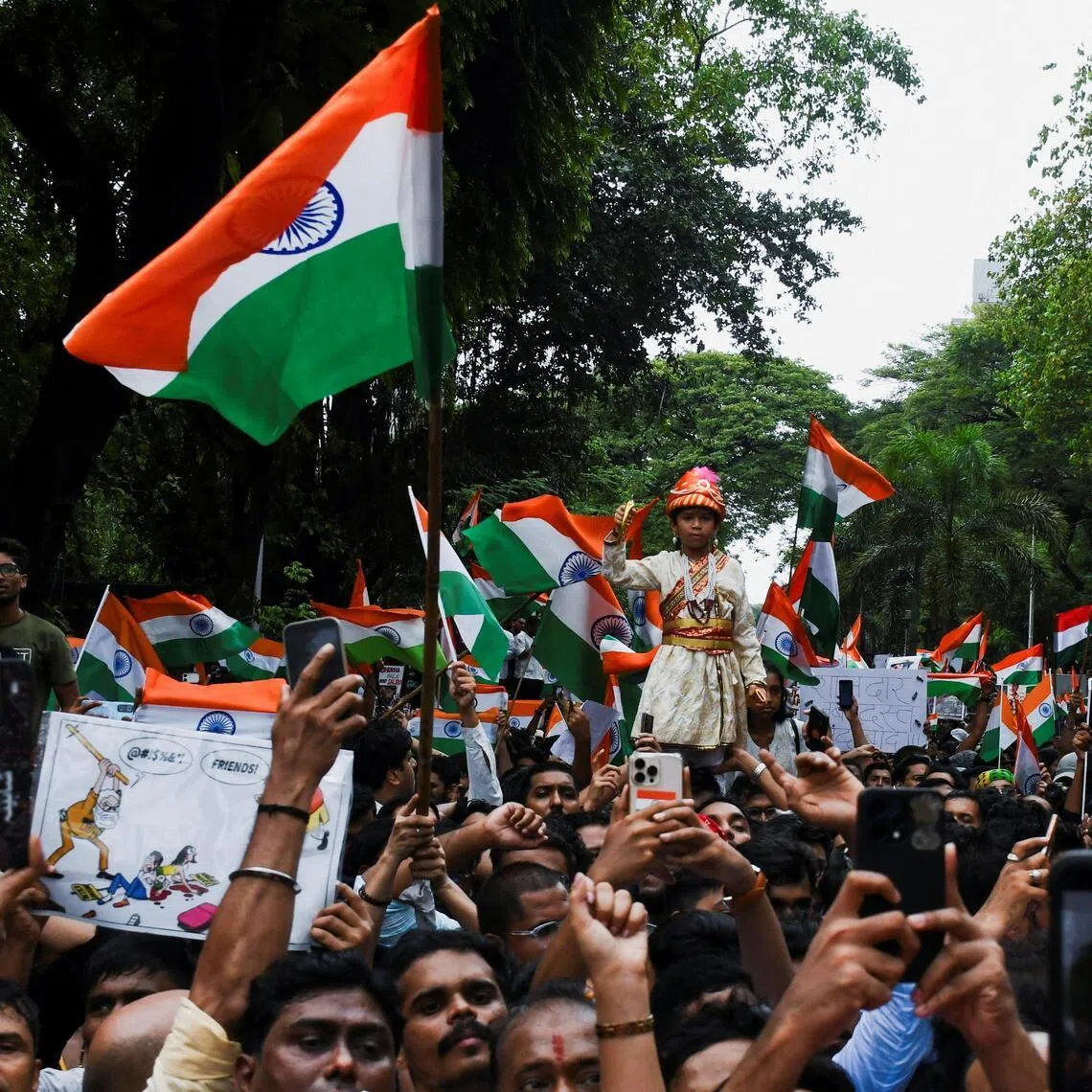 Cockroach Janta Party supporters celebrate the resignation of Education Minister Dharmendra Pradhan, following a protest, in Mumbai, India, on July 26.