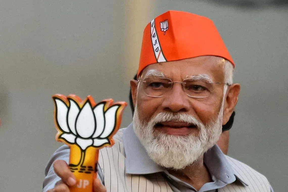 FILE PHOTO: India's Prime Minister Narendra Modi greets supporters during his roadshow, ahead of the general elections, in Ghaziabad, India, April 6, 2024. REUTERS/Anushree Fadnavis/File Photo