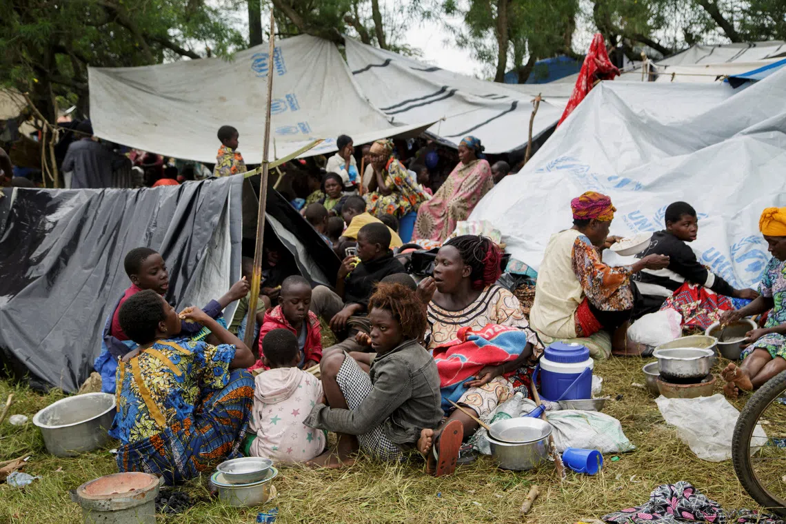 Congolese civilians eat at a reception center in Gatumba, a police camp near the border post that temporarily shelters people who fled renewed tensions between M23 rebels and the Armed Forces of the Democratic Republic of the Congo (FARDC), in Gatumba, Burundi, December 11, 2025. REUTERS/Evrard Ngendakumana
