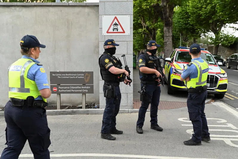 Members of the Garda stand outside the Special Criminal Court where alleged Irish crime gang boss Daniel Kinahan is due to appear, in Dublin, Ireland.