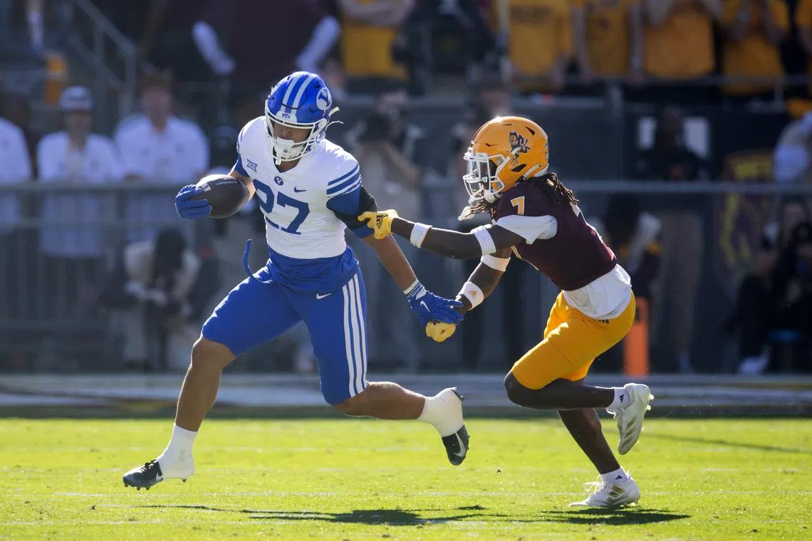Nov 23, 2024; Tempe, Arizona, USA; Brigham Young Cougars running back LJ Martin (27) against Arizona State Sun Devils defensive back Shamari Simmons (7) at Mountain America Stadium. Mandatory Credit: Mark J. Rebilas-Imagn Images/ File Photo