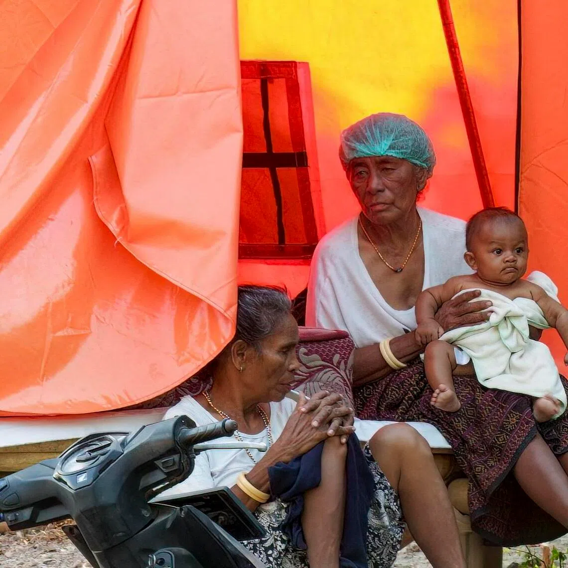 Evacuees resting outside an evacuation centre at Rokirole village, East Nusa Tenggara province, on Sept 17.
