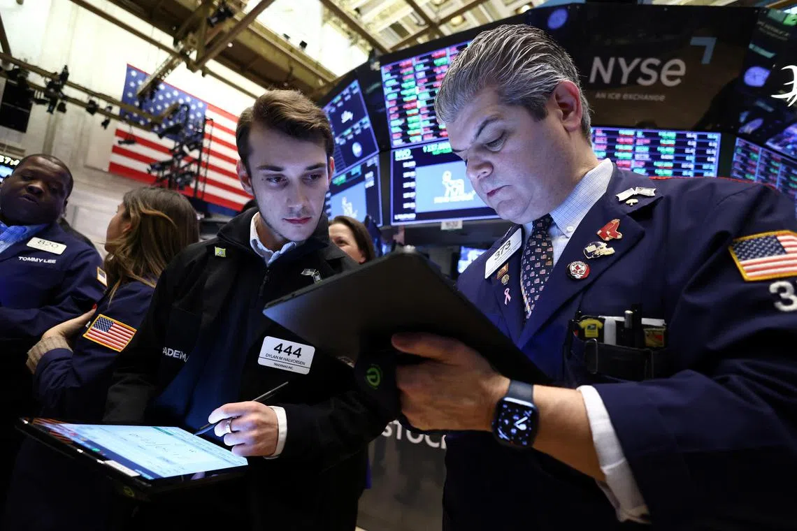 Traders work on the floor at the New York Stock Exchange, on Jan 27, 2023.