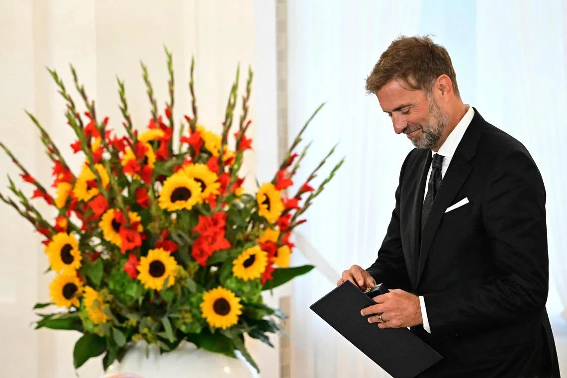 Jurgen Klopp holds the box with his medal after being awarded with the Federal Cross of Merit on Oct 1, 2024 at the presidential Bellevue Palace in Berlin. 