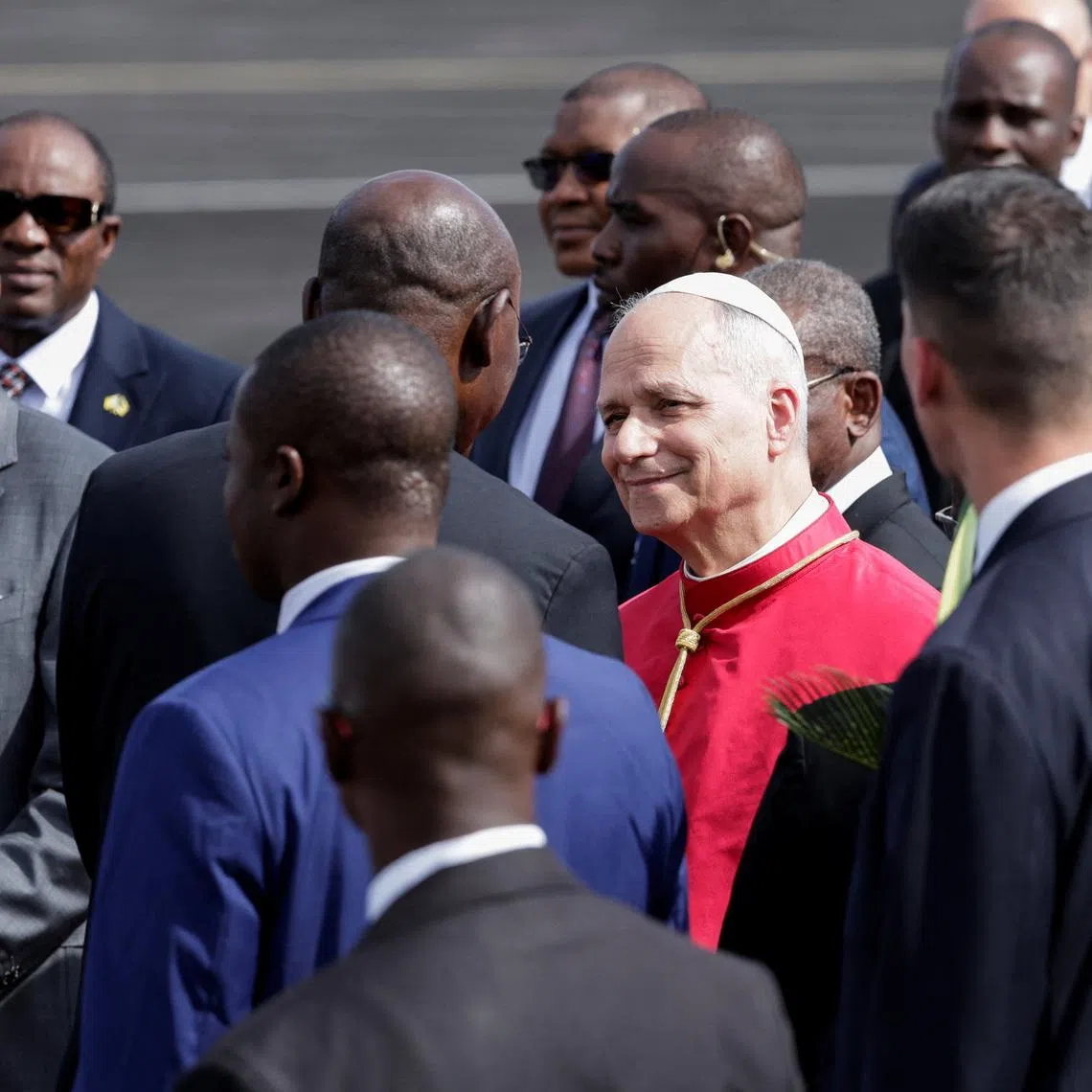 Pope Leo XIV is welcomed upon his arrival at Yaounde Nsimalen International Airport to begin his apostolic journey to Cameroon, in Yaounde, Cameroon, April 15, 2026. REUTERS/Luc Gnago