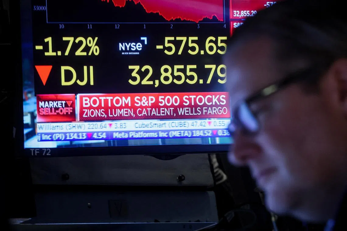 A trader works on the floor of the New York Stock Exchange, in New York City, on March 7, 2023.
