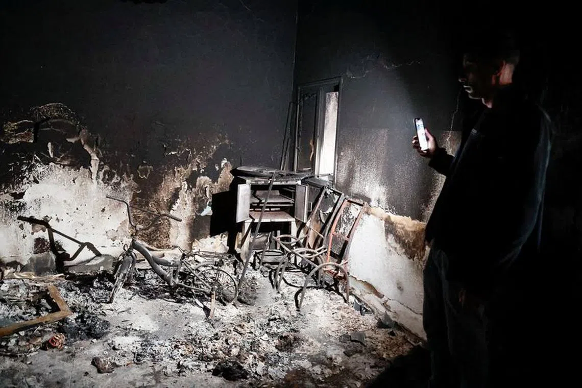 FILE PHOTO: A Palestinian man inspects the damage following an Israeli raid, amid the ongoing conflict between Israel and the Palestinian Islamist group Hamas, in Jenin camp, in the Israeli-occupied West Bank December 14, 2023. REUTERS/Raneen Sawafta/File Photo